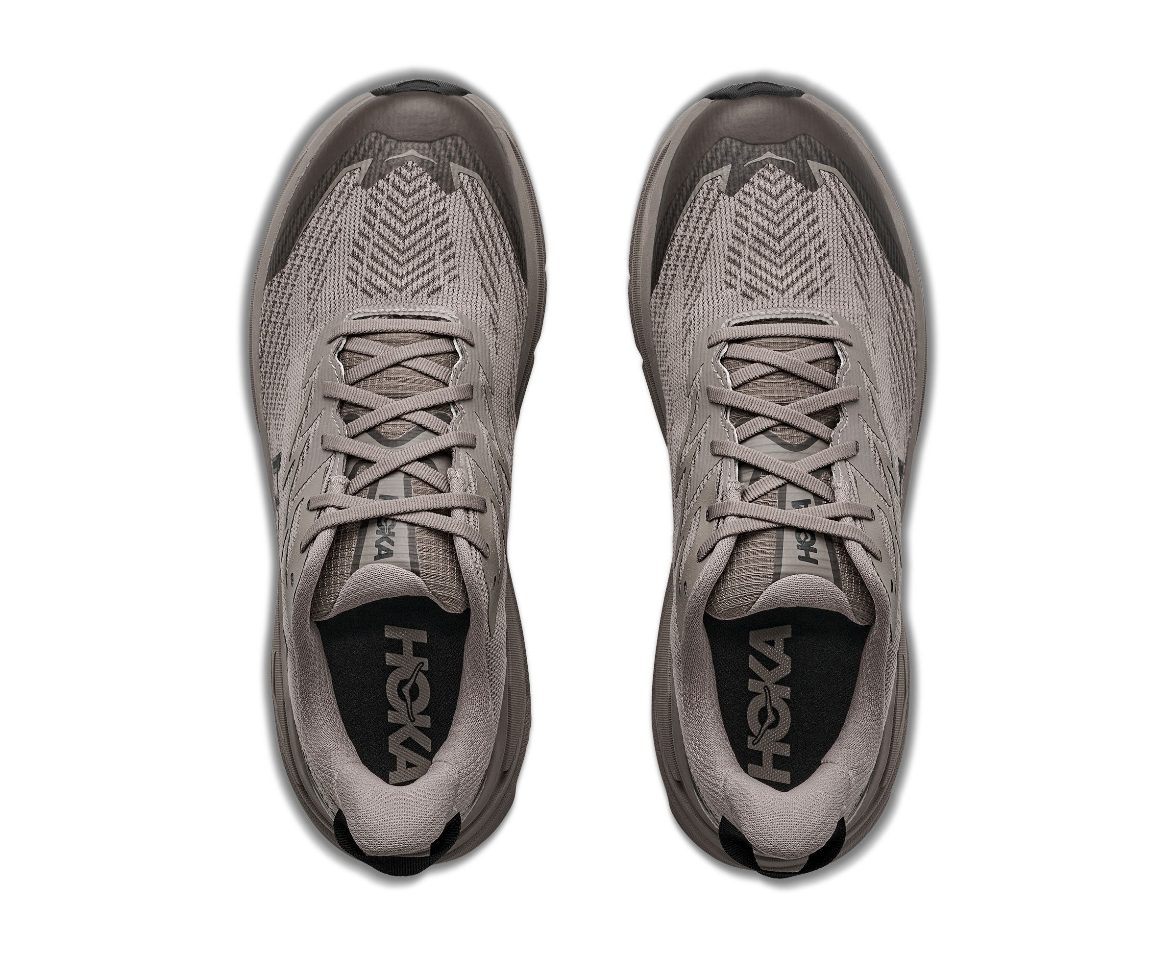 Pair of gray running shoes with 'HOKA' branding on a white background