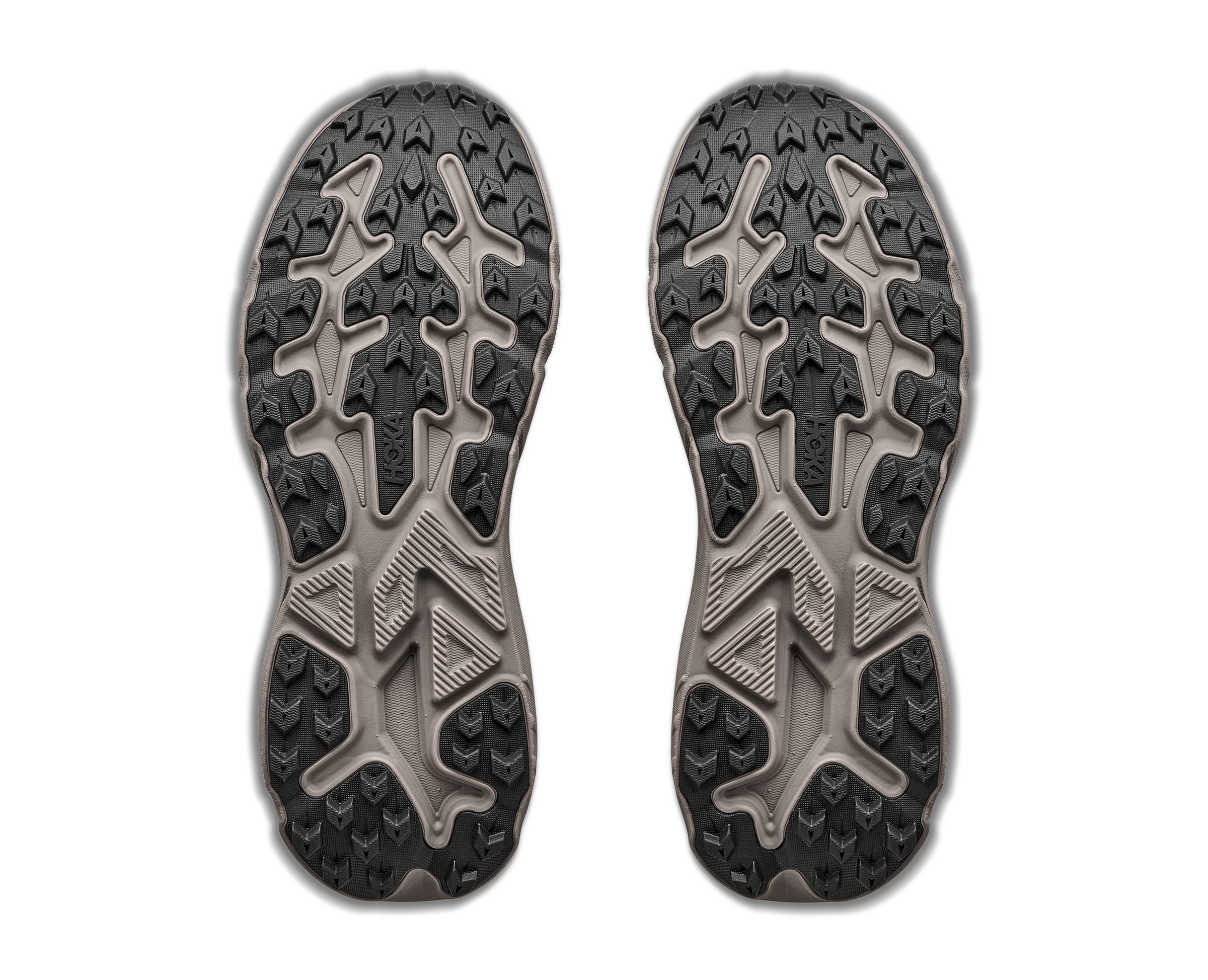 Close-up of a pair of black and gray shoe soles on a white background