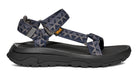 Black sandal with blue patterned straps on a white background