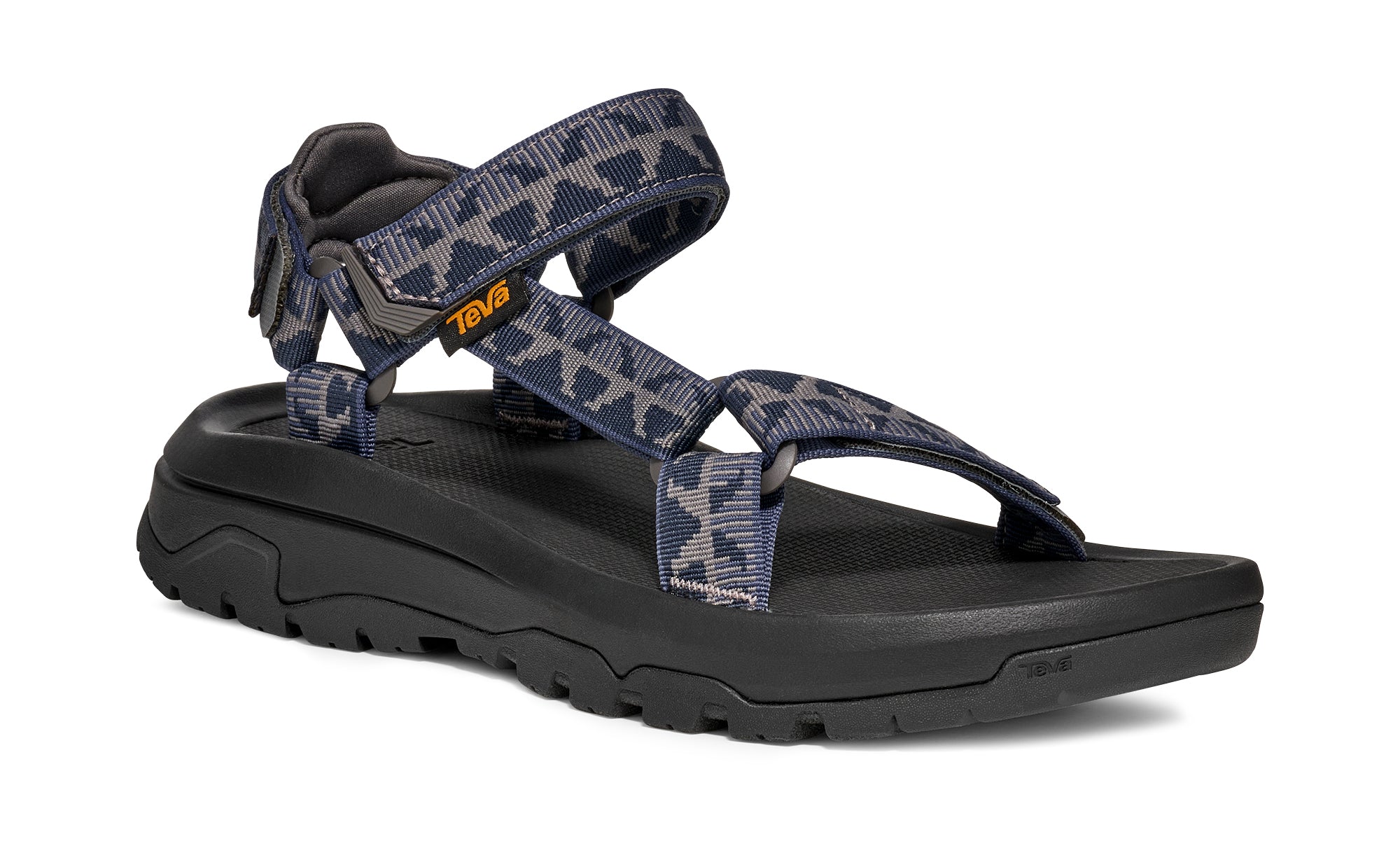 Black sandal with patterned straps on a white background