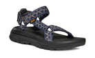 Black sandal with patterned straps on a white background