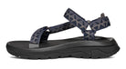 Black sandal with blue patterned straps on a white background