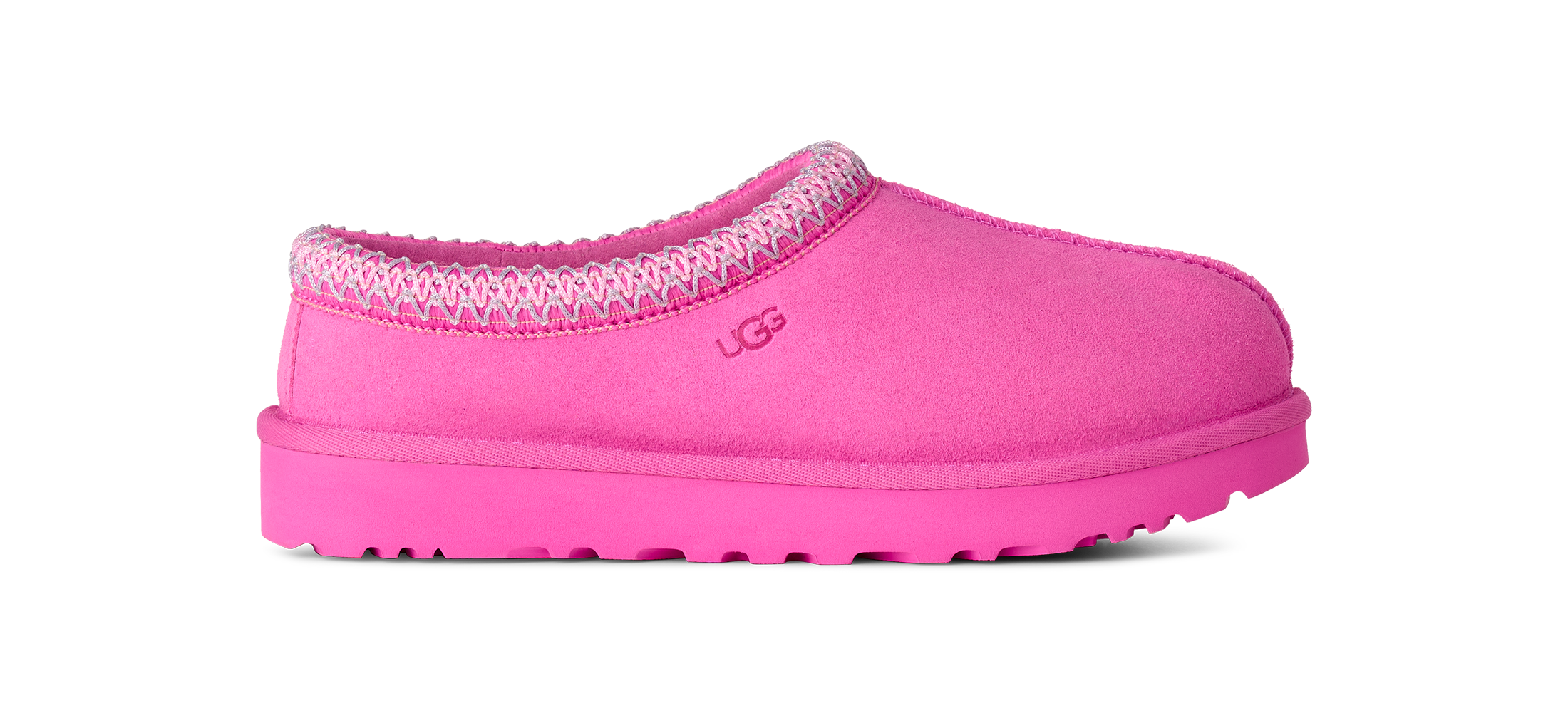 A single UGG slip-on clog shoe in bright pink suede with a textured pink sole and a patterned pink and white knit trim around the collar, shown against a plain white background.