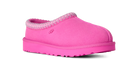 A single UGG slip-on clog shoe in bright pink suede with a matching pink sole and a pink and white patterned trim around the collar, shown on a plain white background.