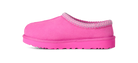 A single bright pink slip-on clog-style shoe with a textured knit trim around the opening and a matching thick sole, shown in side profile on a white background.