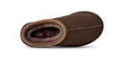 A single brown UGG slipper shown from a side profile view against a white background, featuring a suede-like finish, a decorative braided trim, and a plush brown interior with the UGG logo visible.