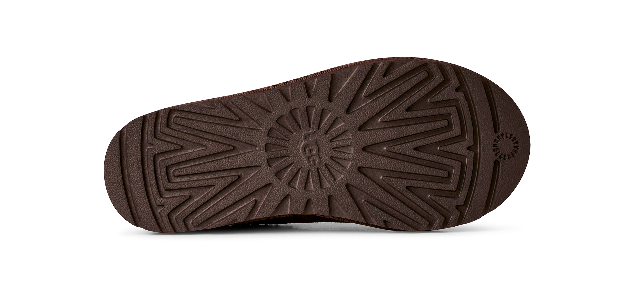 A close-up, top-down view of a dark brown shoe sole, showing its textured tread pattern and a small circular logo near the heel, set against a plain white background.