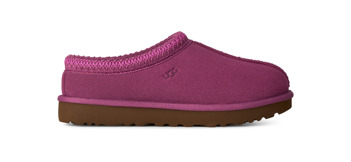 A single UGG slip-on clog shoe in a magenta pink suede-like material with a matching knit collar and a brown sole, shown against a plain white background.