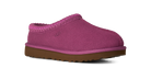 A single UGG slip-on clog shoe in a vibrant magenta pink suede-like material with a matching pink braided trim and a brown rubber sole, shown against a plain white background.