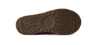 The bottom sole of a shoe, featuring a dark brown textured tread pattern with a circular logo in the center and a small sunburst mark on the heel, shown against a plain white background.