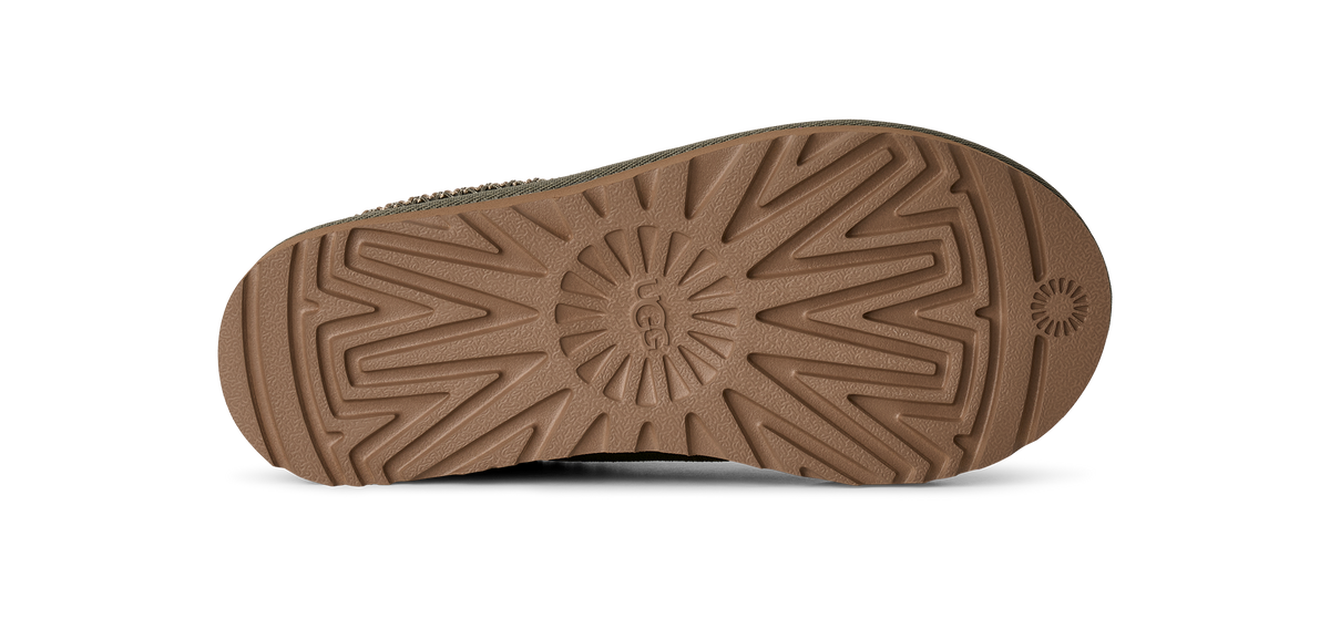 The textured brown rubber outsole of a shoe, photographed from directly underneath against a solid white background.