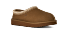 A single brown suede slipper from UGG, featuring a textured knit trim around the collar and a thick brown sole, shown against a plain white background.