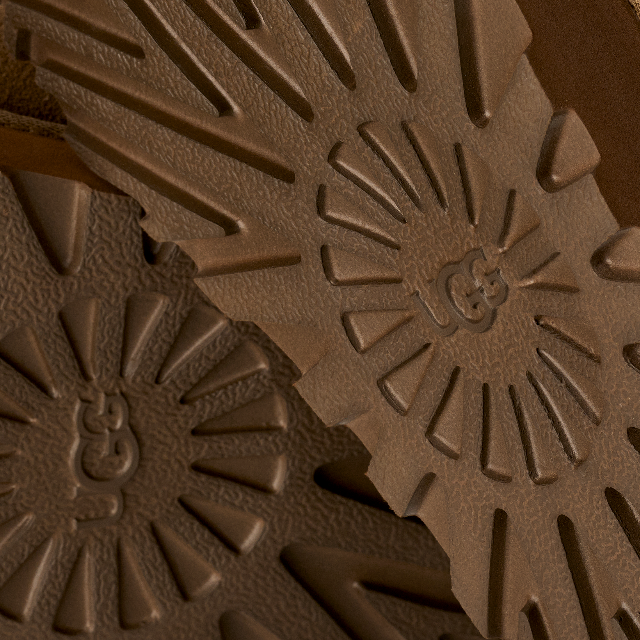 Close-up of brown textured material with a brand logo