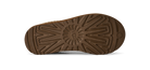 The brown rubber outsole of a boot, showing a detailed tread pattern and a small embossed logo on the heel, photographed against a solid white background.