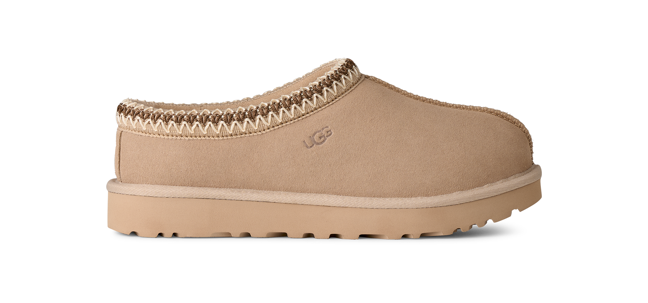 Beige slip-on shoe with brown trim on a white background