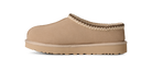 Tan slip-on shoe with a textured sole on a white background