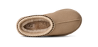 Tan UGG slipper with brand logo on a white background