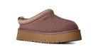 Brown slip-on shoe with a platform sole on a white background