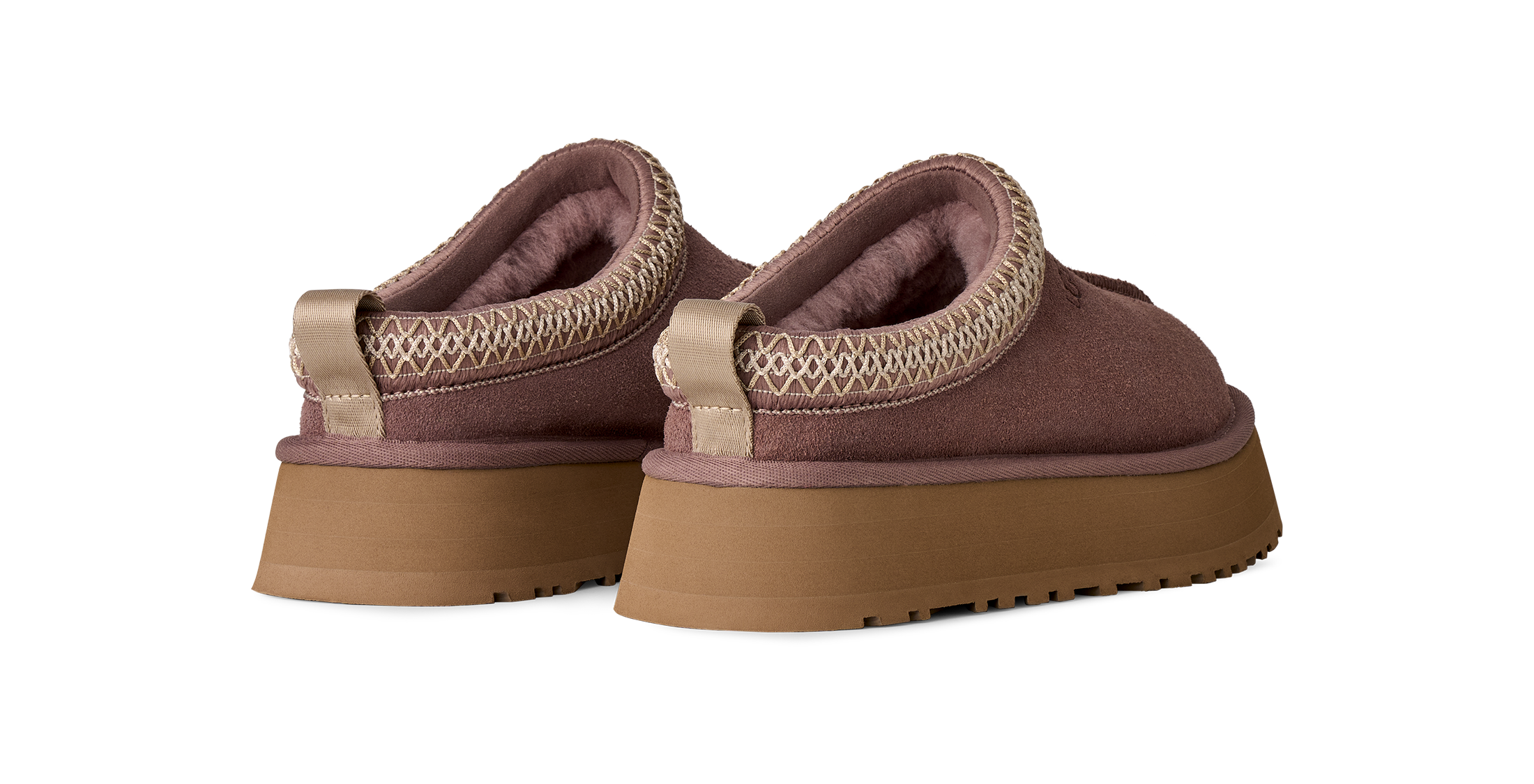 A pair of slip-on platform slippers in a dusty mauve-brown color, featuring a textured knit trim around the collar and a thick tan sole, shown against a plain white background.
