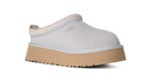 White UGG slip-on shoe with a brown sole on a white background