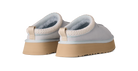 Pair of light gray shoes with beige soles on a white background