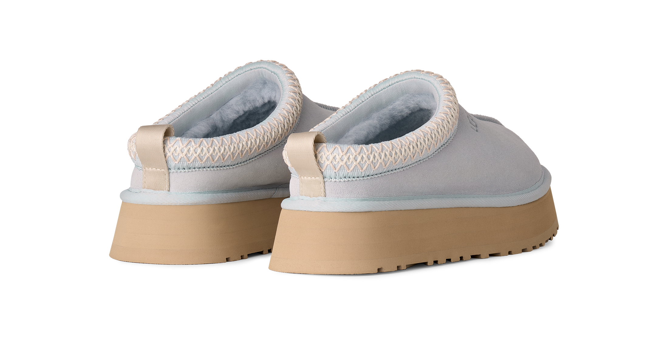Pair of light gray shoes with beige soles on a white background