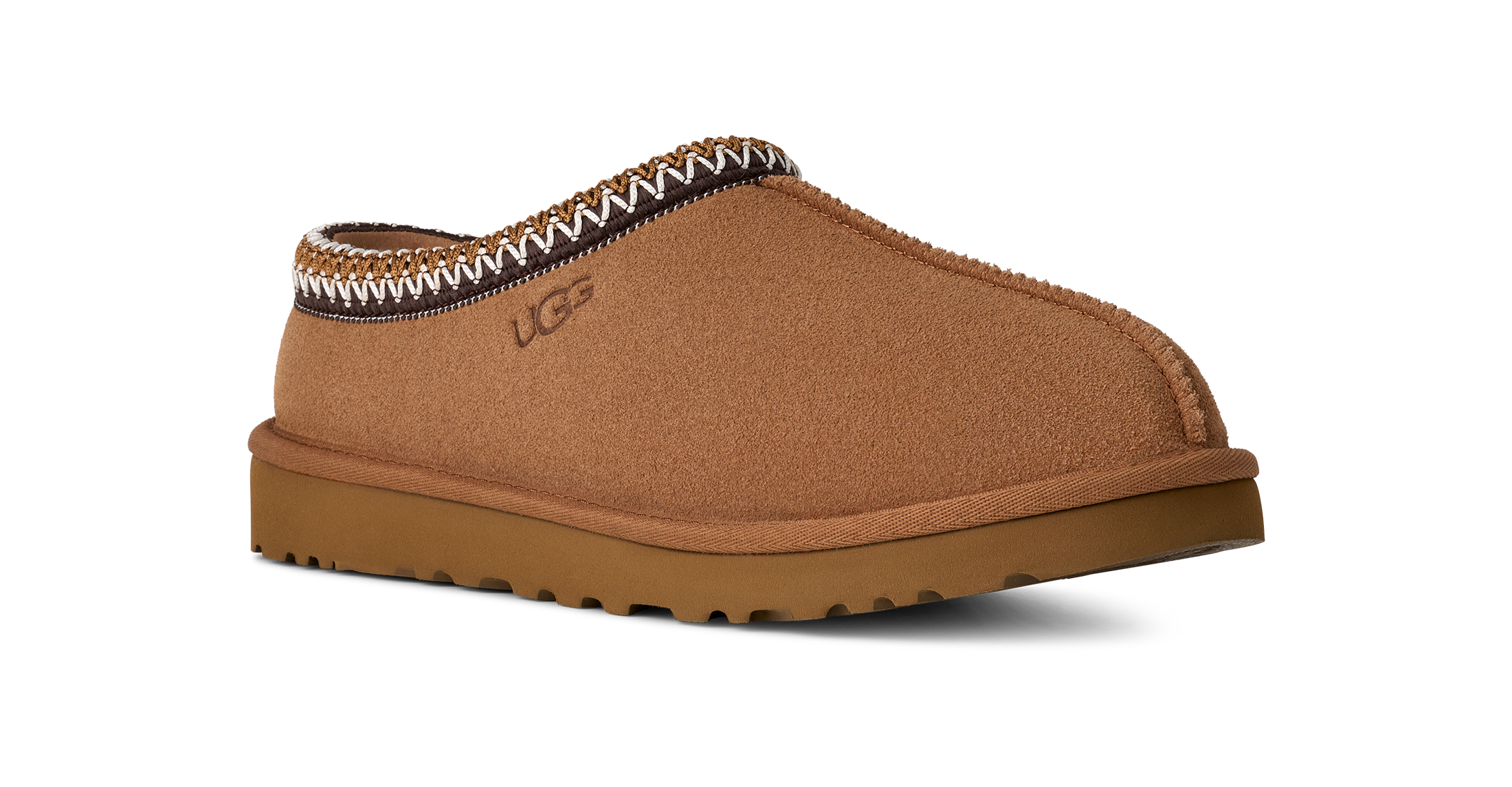 Brown UGG slipper with decorative trim on a white background