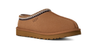 Brown UGG slipper with decorative trim on a white background