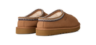 Brown slippers with decorative trim on a white background
