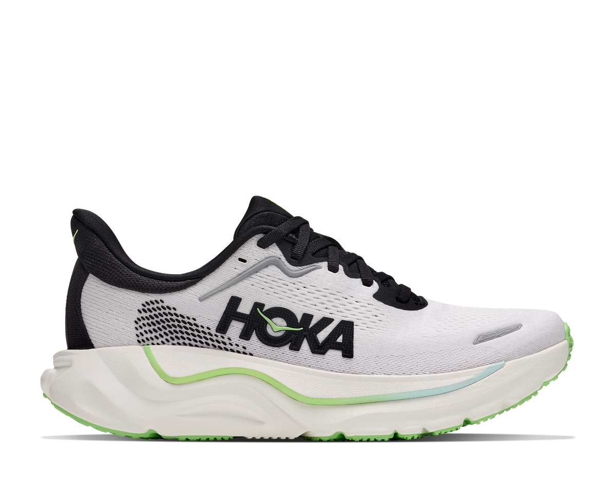 A Hoka running shoe in white and black with neon green accents, shown from the side profile on a white background.