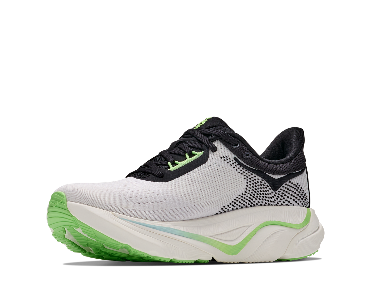 A single athletic running shoe shown in profile against a solid white background. The shoe features a white mesh upper with black accents, a black and white patterned side panel, a thick white midsole with a light blue accent line, and a bright green outsole and heel accent.