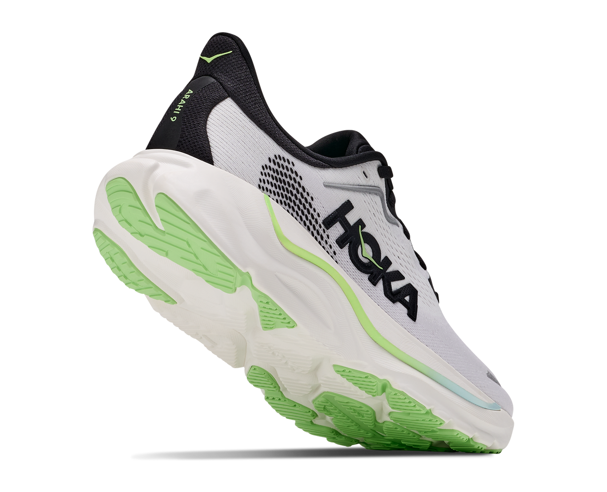 A Hoka running shoe in white, black, and neon green, shown from a three-quarters angle against a plain white background.