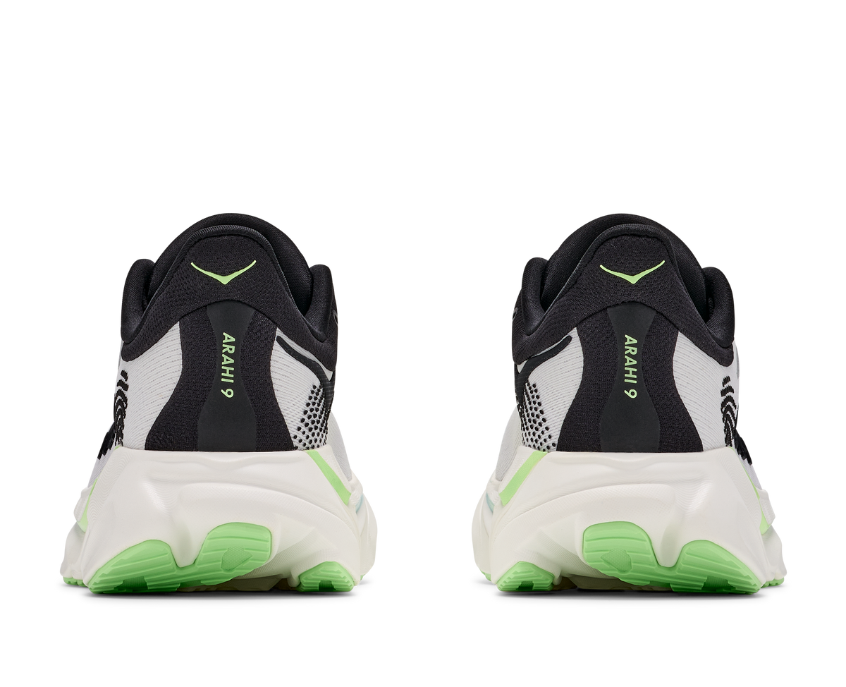 A pair of black and white running shoes shown from the back, featuring bright neon green accents on the midsole and heel, with the model name 'ArAHi 9' printed vertically on the heel counter.