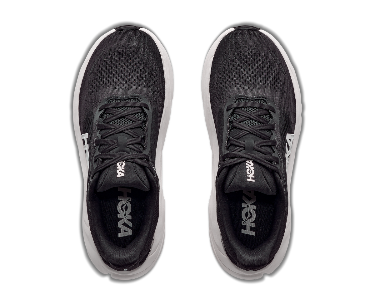 Black running shoes with white soles on a white background