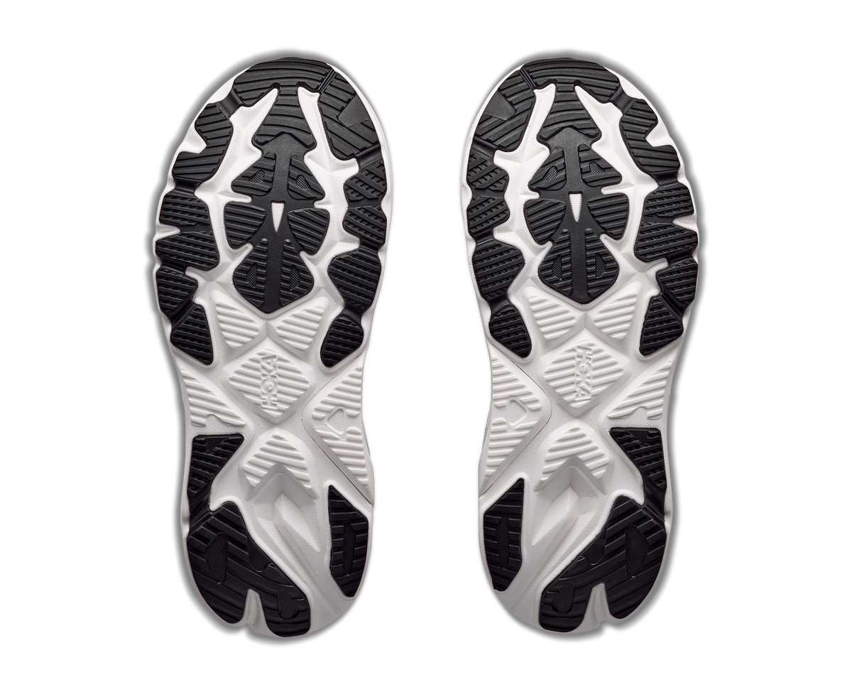 Close-up of the sole of a shoe with black and white tread pattern on a white background