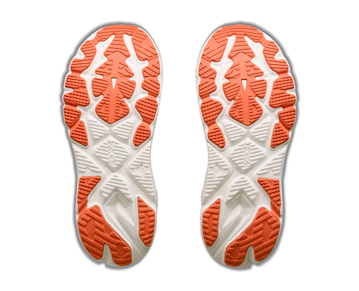 Close-up of a pair of white and orange shoe soles on a white background