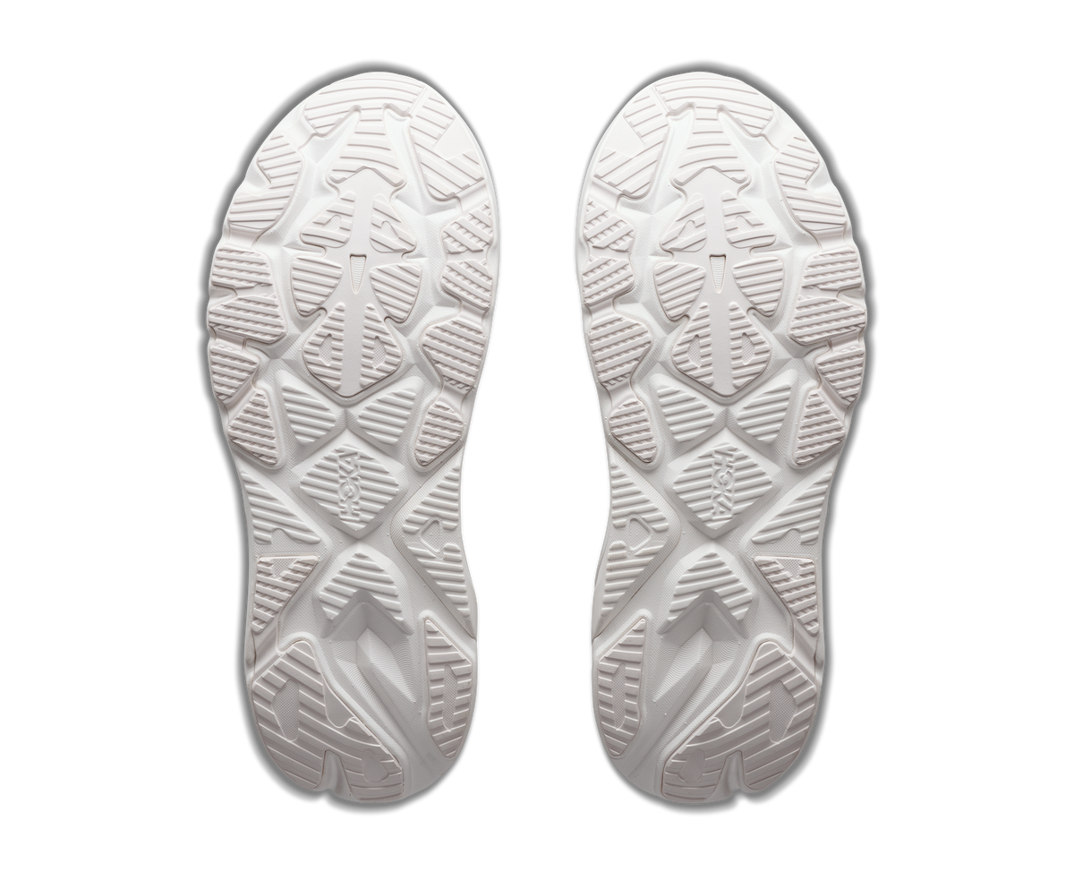 A pair of white athletic shoes shown from the sole view, displaying detailed tread patterns against a plain white background.