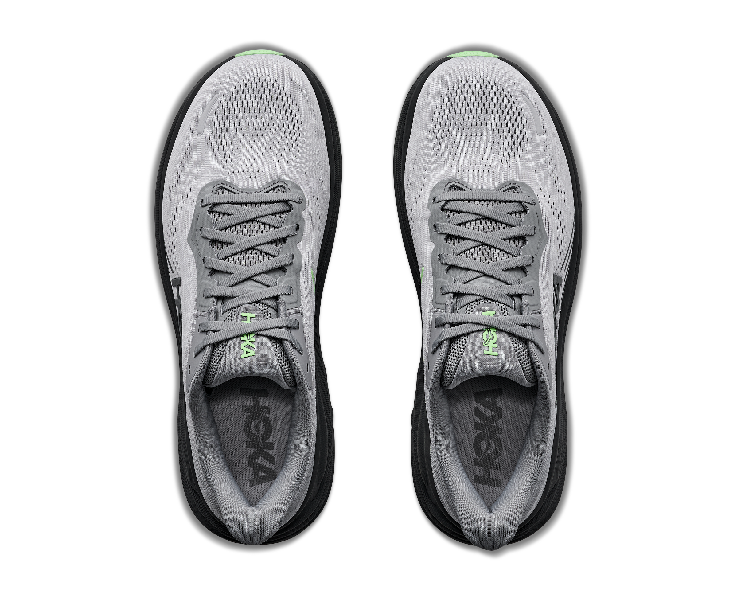 Gray running shoes with black soles on a white background