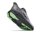 Gray running shoe with green sole on a white background