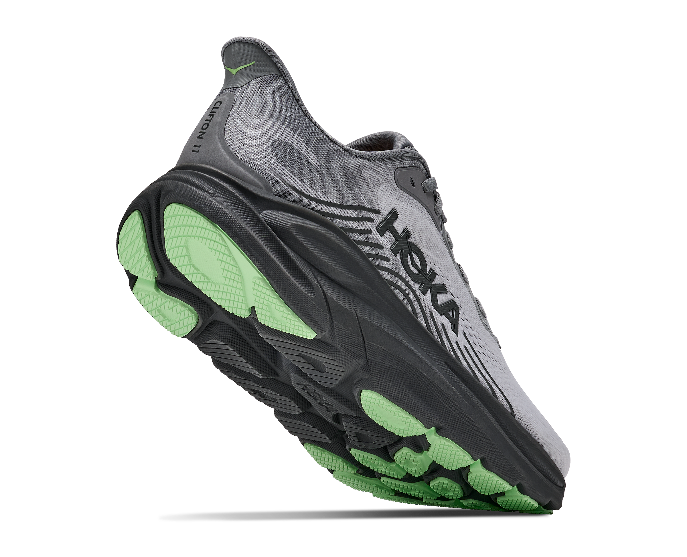 Gray running shoe with green sole on a white background