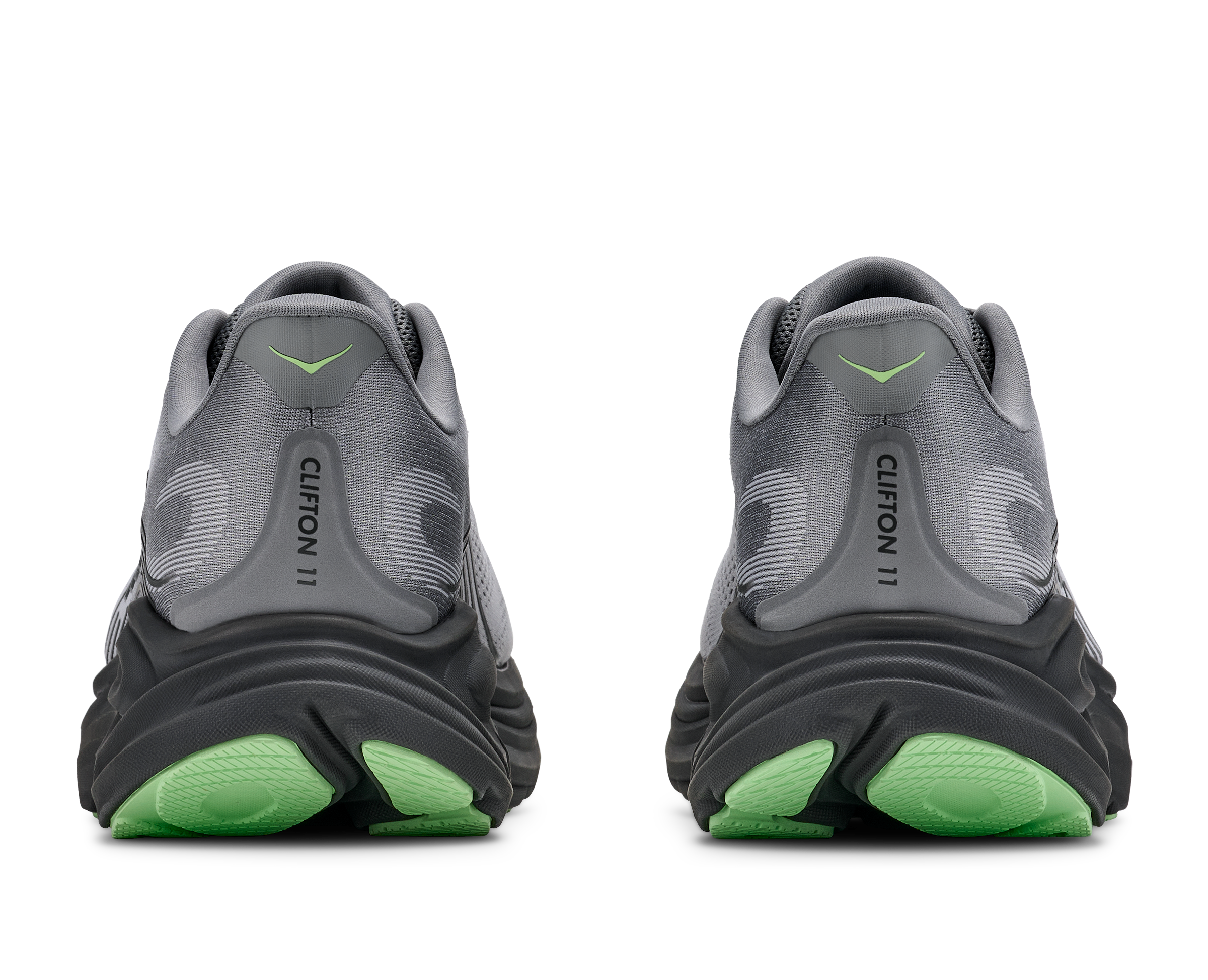 Gray running shoes with green soles on a white background