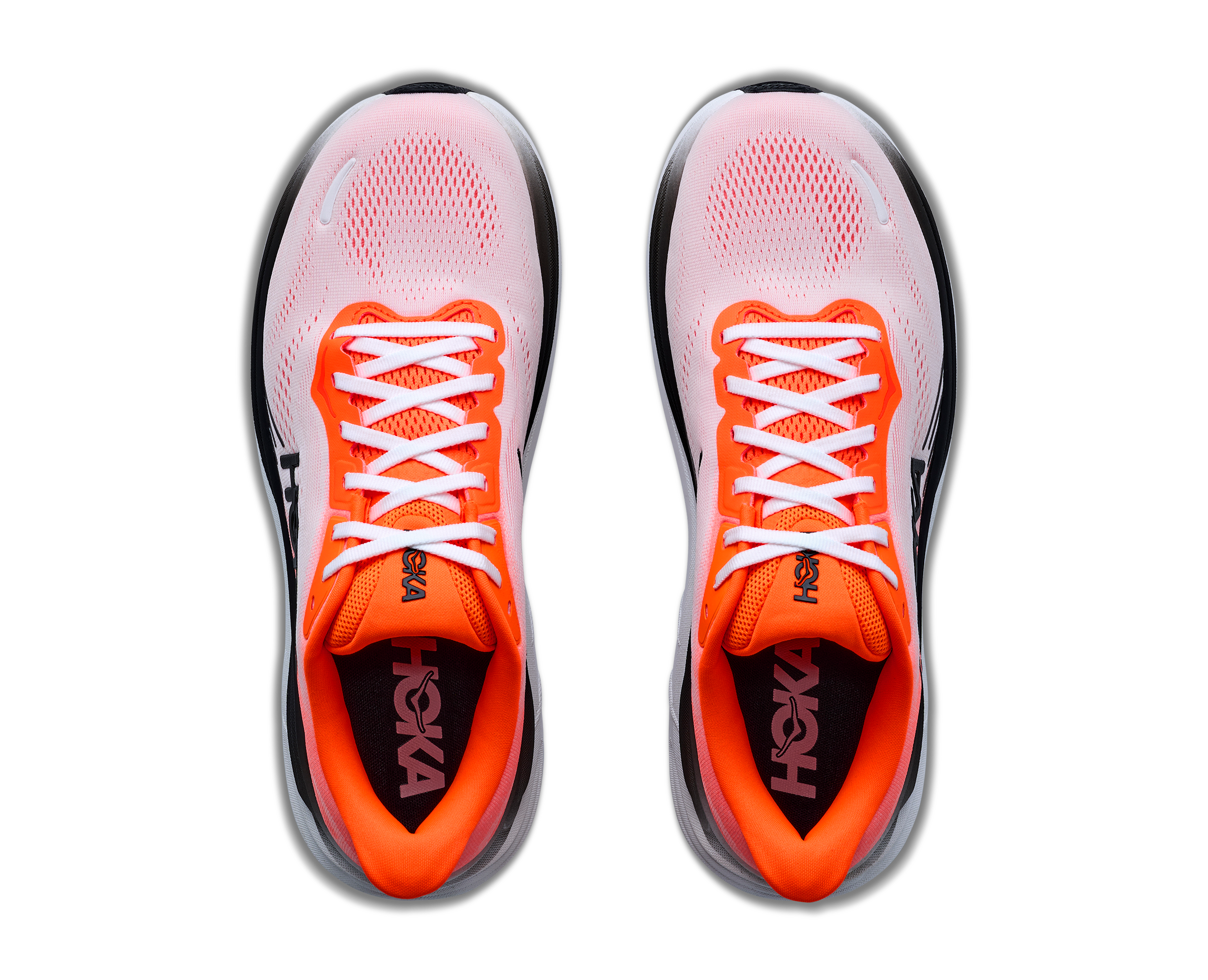 Pair of pink and orange running shoes with 'Hoka' branding on a white background