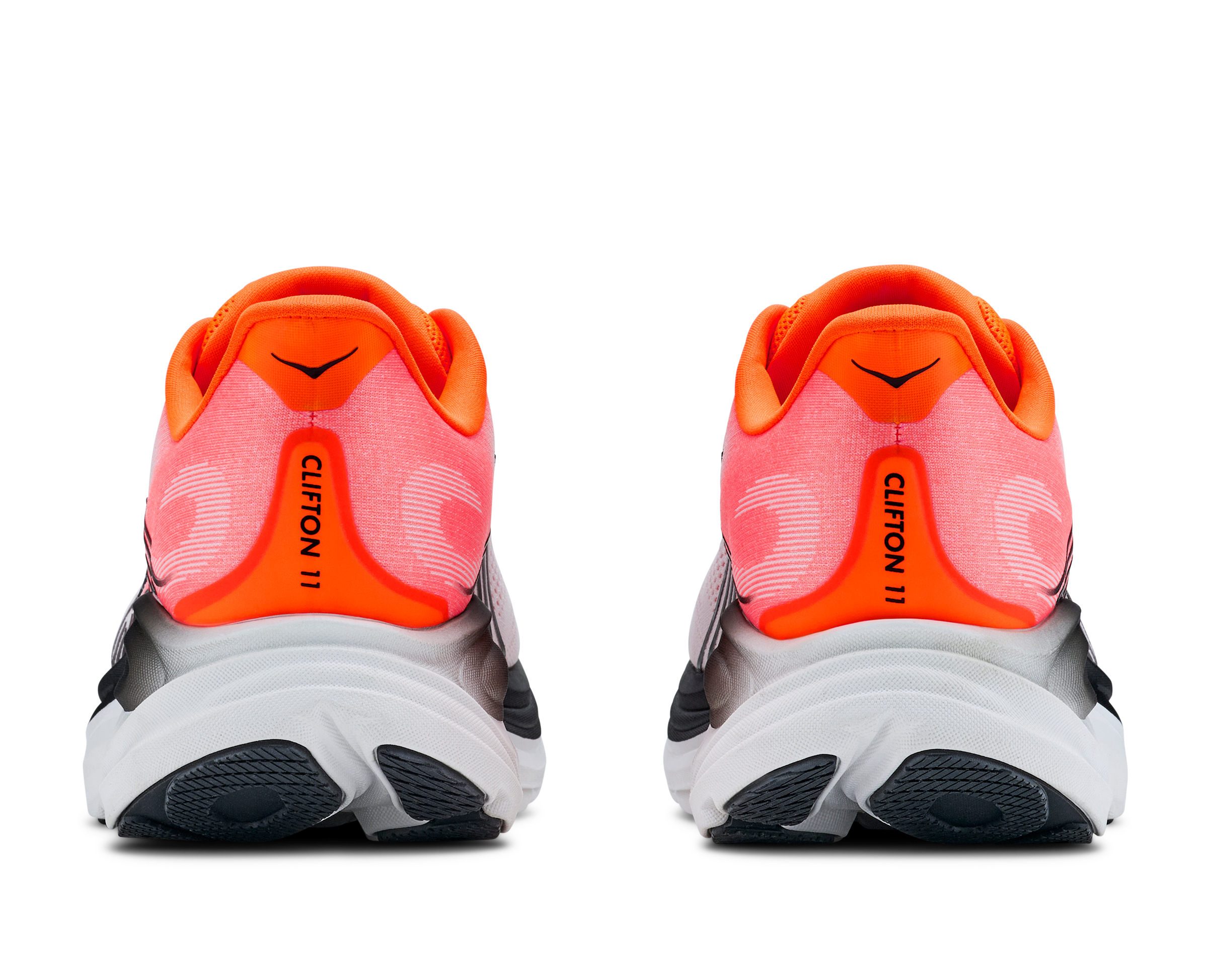 Pair of orange and black running shoes on a white background