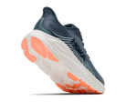 Blue running shoe with orange sole on a white background