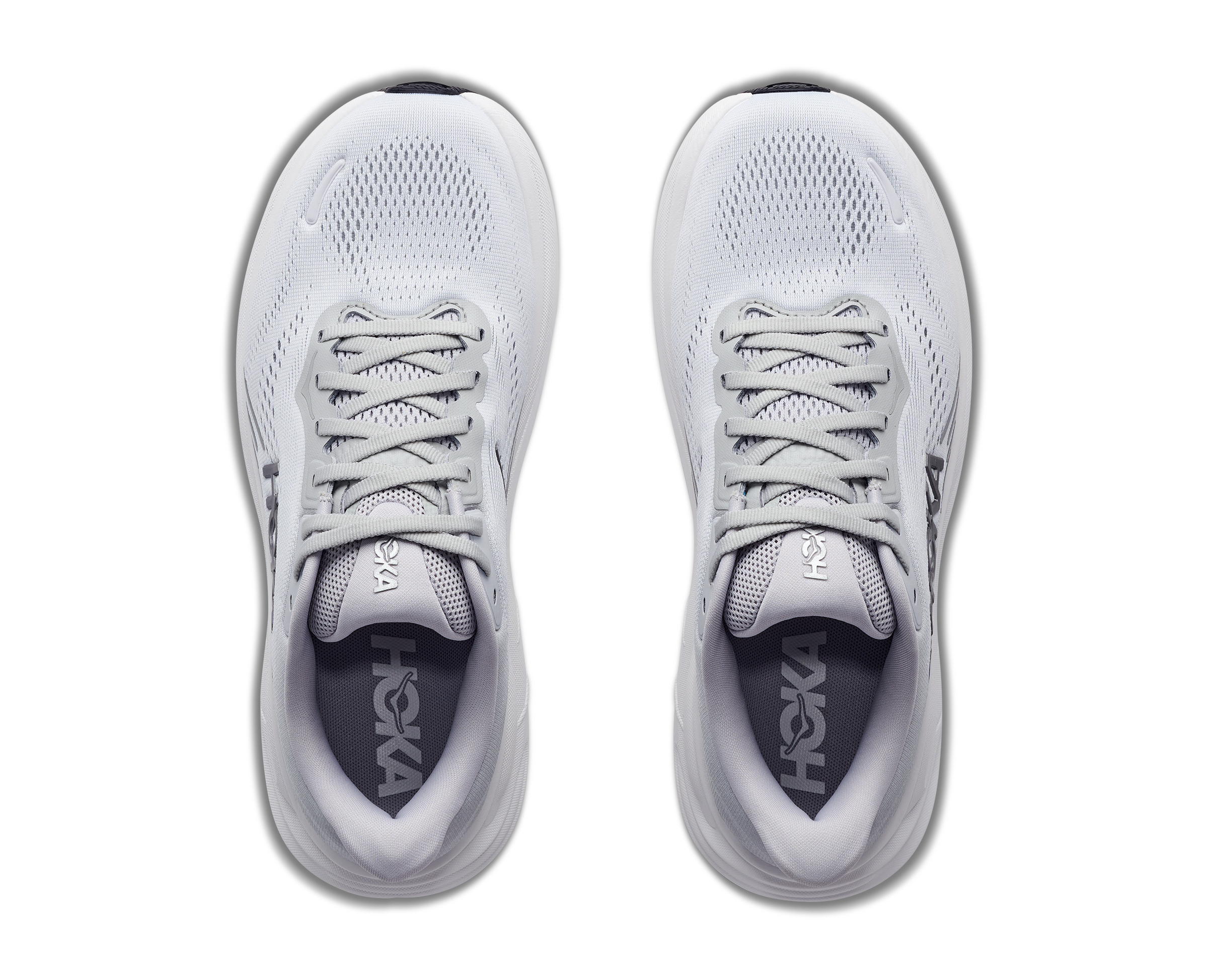Pair of white running shoes with 'On' branding on a white background
