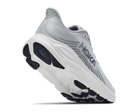 A Hoka running shoe in light gray and white with black outsole details, shown from a three-quarters angle on a white background.
