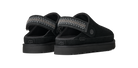 A pair of black UGG slide sandals with textured gray woven straps, shown from a three-quarters angle on a plain white background.