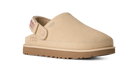 A beige UGG slip-on clog shoe with a tan sole, shown from a side profile on a white background.
