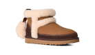 A brown suede ankle boot with thick cream shearling-style trim and a matching pom-pom, shown from a side profile on a white background.