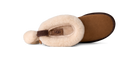 A single UGG slipper shown from a side profile view on a white background, featuring a cream-colored shearling upper, a brown suede-like footbed, and a brown heel pull tab.
